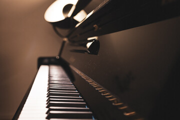 Upright piano details in cozy indoor night lighting © Thomas Lemmer