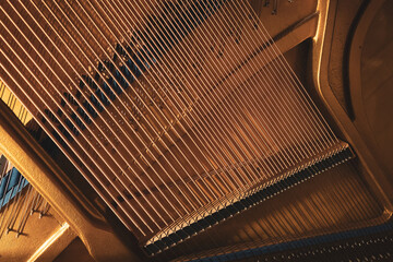 Upright piano details in cozy indoor night lighting © Thomas Lemmer