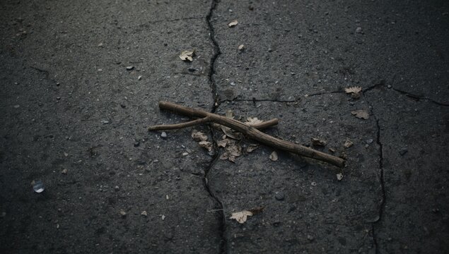 Center stripe on weathered asphalt, serving as a traffic guide, with surface cracks and degradation