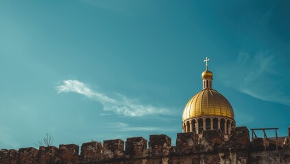 Church with a golden dome and cross on a clear blue sky, highlighting religious architectural heritage
