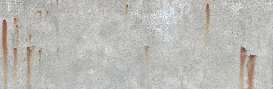 Weathered grey concrete wall showing rust stains