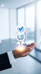 Businessmans hand holding a glowing badge with checkmarks, symbolizing quality assurance and business excellence in a modern office setting.