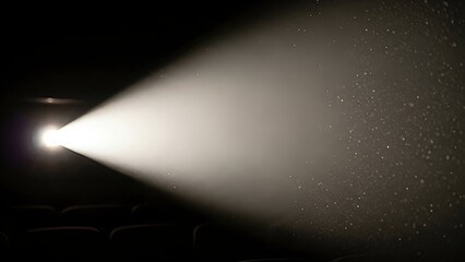 Bright cinema projector light beam cutting through the darkness with visible dust particles. Movie theater atmosphere and entertainment concept.