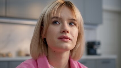 Calm sad lonely Caucasian woman girl sitting couch at home thinking health problem looking away...