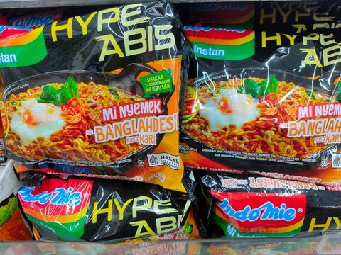 Malang, Indonesia - November 24, 2025: Indomie instant noodles fill a store shelf. Hype Abis, Mi Nyemek bangladesh kari. Indomie goreng.