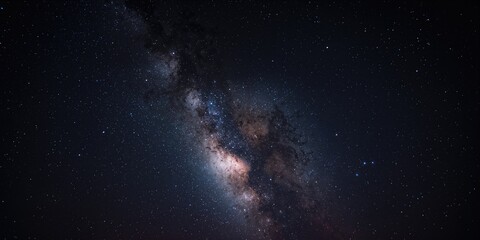 Fototapeta premium The Milky Way stretching across the dark sky, used as a celestial background for stargazing, International Astronomy Day