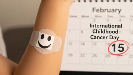 Calendar marking February 15 with bandage featuring smiley face, for International Childhood Cancer Day awareness