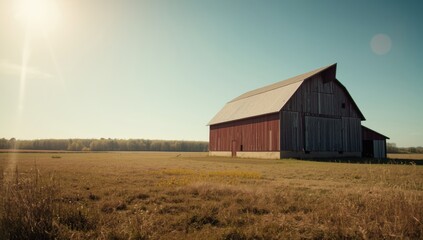 Obraz premium Classic rural barn featuring metal exterior and open sky, suitable for agricultural setting