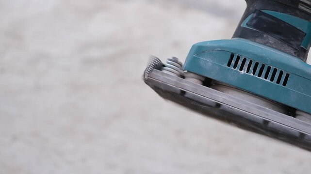 sander polishing wood with high pitched sound. Power tool used to smooth surfaces by abrasion with sandpaper