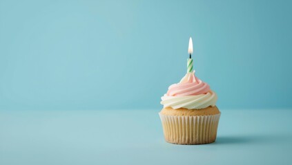 Single candle on birthday cupcake against blue backdrop, highlighting personal achievement and marking special days