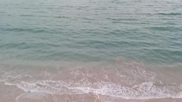 A great view of a beach, the Mediterranean Sea and the sky is next to Bridge 45. The view is near the sunrise. The bridge is on the Corniche Road in Alexandria, Egypt. It has a pedestrian walkway.