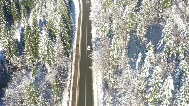 Aerial view of country road going through the snow covered landscape. Gorski kotar, Croatia