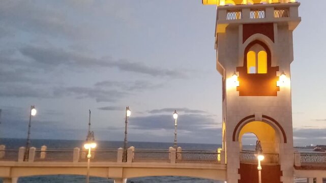 This is Bridge 45. The bridge has a pedestrian walkway. The opening was in 2023. A great view of the sky and the Mediterranean Sea is behind the bridge. The view is near the sunrise.