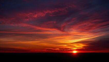 Fototapeta premium Colorful sunset with clouds illuminating the horizon for scenic imagery, seasonal change