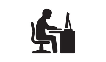 Silhouette of a person sitting at a workspace desk and working on a computer monitor