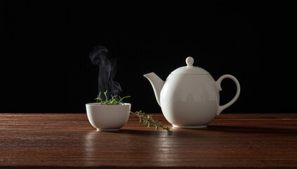 Fototapeta premium Herbal thyme tea made with a tea infuser and white teapot, focusing on natural ingredients and infusion process