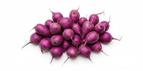 Fresh purple yams laid out on a white background for food styling and recipe development