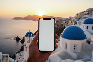 Smartphone foreground with Santorini blue domes sunset