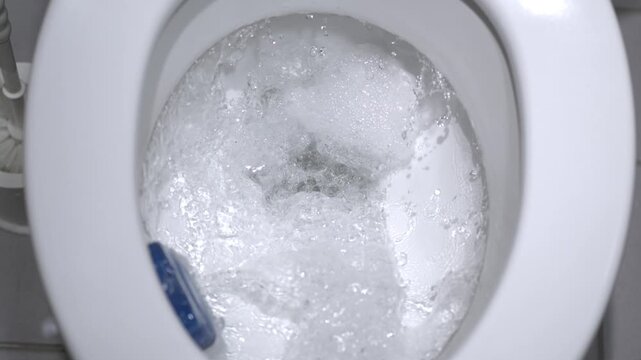 Super Slow Motion Visual Scene Of Bathroom Toilet Bubbling With Foam As It Finalizes Its Flush Operation