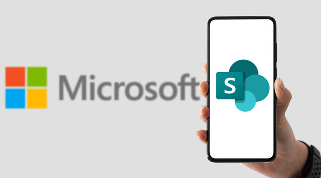 Microsoft technology with smartphone and SharePoint logo on screen
