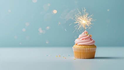 Decorative cupcake topped with a lit sparkler on a blue background, suitable for party or holiday visual layouts
