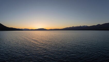 Fototapeta premium Lake Tahoe at sunset with tranquil waters, highlighting seasonal change, Earth Day