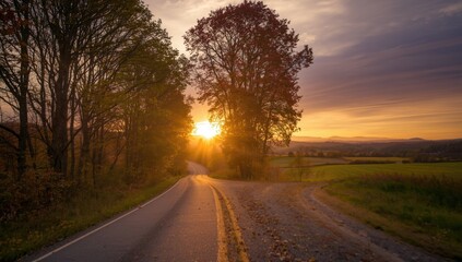 Fototapeta premium Sunset over a landscape with a traffic road, trees, and sky emphasizing fall scenery, seasonal change