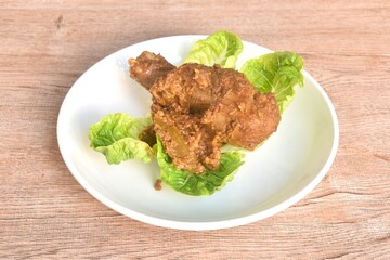 fried chicken leg herb curry and baby cos lecctue on plate