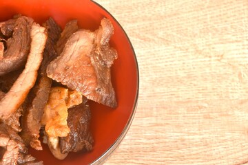 fried crispy salty fermenting beef fat meat with pepper on bowl