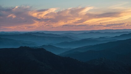 Wide view of undulating hills in blue tones beneath a cloudy sky at dusk, highlighting landscape erosion risk
