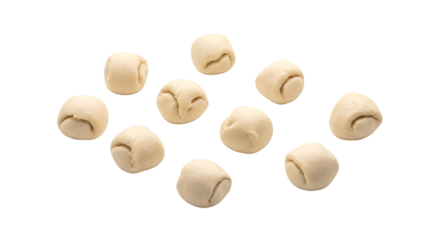 Scattered group of small, light-colored dough balls on white background