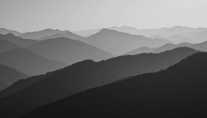 Monochrome mountain range landscape with rolling hills and misty atmosphere