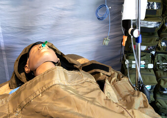 Rescue drill with mannequin inside a German military tent, medical equipment visible, realistic emergency simulation