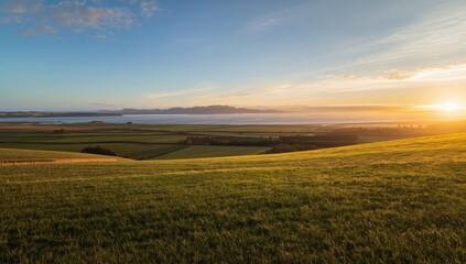 Obraz premium Sunrise illuminating agricultural fields, highlighting crop cycles and daylight duration