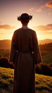 Silhouette of person with crown looking at sunset. Peaceful atmosphere creates reflection and serenity. Landscape reveals lush green hills at dusk. Vertical shot captures tranquility.