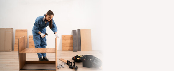 Female craftsman assembles furniture. Concept of Professional furniture assembling.