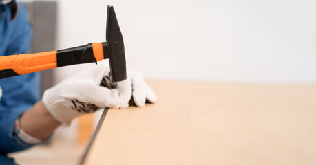 Concept of hobbies and DIY. hammering nails into wood