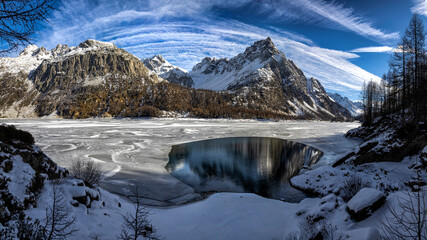 Beautiful mountain lake on winter landscape. Winter mountain lake. Mountain lake snowy landscape. Mountain winter lake