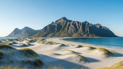 Scenic panorama of white sand beach with turquoise water and majestic mountains