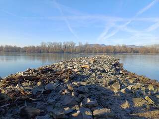Stone spit into calm river