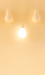 Light bulb illuminating among non-glowing bulbs concept
