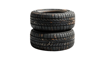 Obraz premium Two worn car tires, one stacked upon the other, isolated against black background