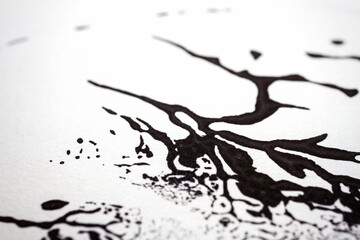 Extreme close up of black acrylic paint texture on paper. Selective focus.