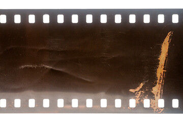 Dusty and grungy 35mm film texture or surface. Perforated scratched camera film isolated on white background.