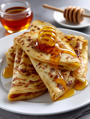 Honey drizzling crepes with dipper for breakfast