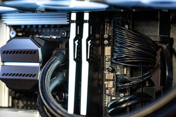 The inside of a modern computer assembled in 2025, showing DDR5 memory and other components.