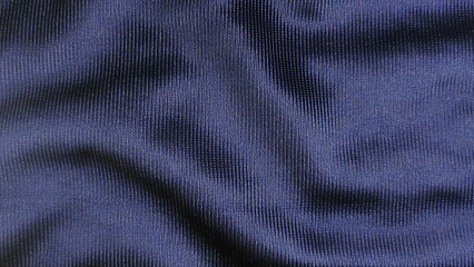 Deep navy blue synthetic sports fabric texture background with vertical ribbed mesh pattern design