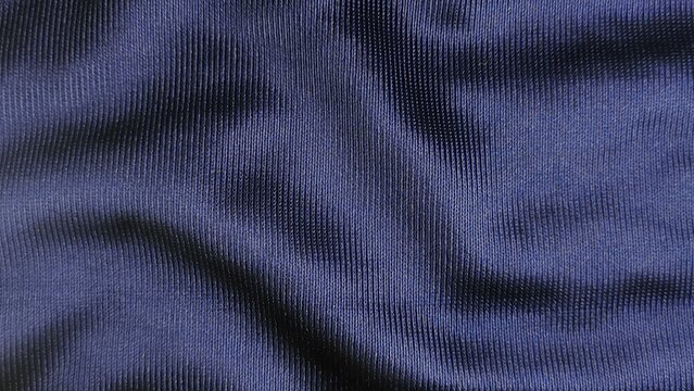 Deep navy blue synthetic sports fabric texture background with vertical ribbed mesh pattern design