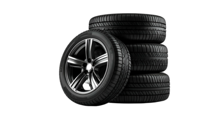 A stack of four black rubber tires, one mounted on a shiny alloy wheel, set against a black backdrop