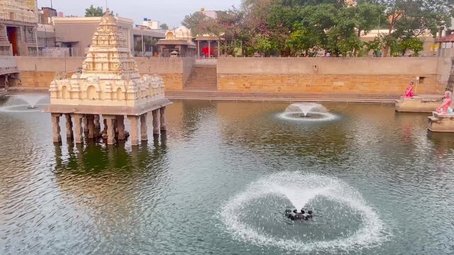 Water Fountain Inside Temple Tank Creating Circular Ripples